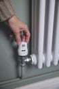 Close Up Of Hand Turning Down Thermostat On Radiator At Home To Save Energy And Money Royalty Free Stock Photo