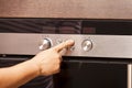 Close Up of Hand Turning Knob on Oven