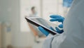 Close up of hand using dental x ray on modern tablet