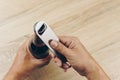 Hand using a stainless steel bottle opener