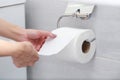 Close-up of Hand Using Toilet Paper. Royalty Free Stock Photo