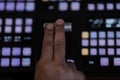 Close up hand on video switcher panel