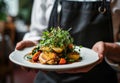 Close-up on the hand of a waiter carrying food, restaraunt serving