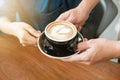 Close-up hand of a waitress serving a cup of coffee to customer. Royalty Free Stock Photo