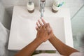Hand wash on basin using soap