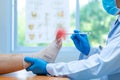 Close-up hand wear medical gloves doctor examines the leg of the womanÃ¢â¬â¢s nerve pain in the foot, plantar fasciitis, osteophyte