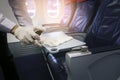 Close up hand is wearing gloves cleaning aircraft seat for covid-19 prevention pandemic Royalty Free Stock Photo