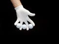 Close-up of a hand wearing a golf glove holding some golf balls between the fingers Royalty Free Stock Photo