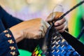 Close up hand of weaver during weaving basket made from plastic