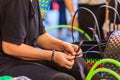 Close up hand of weaver during weaving basket made from plastic