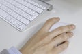 Close up of hand on wireless mouse.