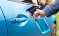 Close up hand of woman cleaning car door handle socket with alcohol spray protection germs Royalty Free Stock Photo