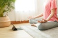 Close up of hand woman doing lotus yoga exercises on yoga mat with Training online on the tablet at home morning, Concept of Royalty Free Stock Photo