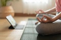 Close up of hand woman doing lotus yoga exercises on yoga mat with Training online on the tablet at home morning, Concept of Royalty Free Stock Photo