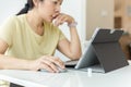 Close up on hand of woman holding mouse of laptop computer working at home.