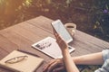 Close up hand woman holding phone in coffee shop, Vintage filter Royalty Free Stock Photo