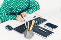 Close-up of hand woman makes notes and using a mouse and typing on keyboard on white table, business concept Royalty Free Stock Photo