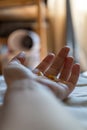 Close up hand of woman overdosing on medication.