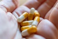 Close up hand of woman overdosing on medication.