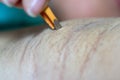 Close up hand of woman plucking armpit hair removal