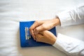 Close up hand woman praying, hands clasped together on her Bible Royalty Free Stock Photo