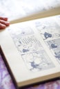 Woman reading Moomin comic book