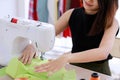 Close up of hand. Woman seamstress sitting works to repair broken clothes using a sewing machine with skill for the customer in