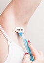 Close up of hand woman shaves armpit disposable razor. Armpits care concept Royalty Free Stock Photo