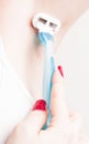 Close up of hand woman shaves armpit disposable razor. Armpits care concept Royalty Free Stock Photo