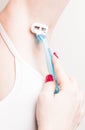 Close up of hand woman shaves armpit disposable razor. Armpits care concept Royalty Free Stock Photo