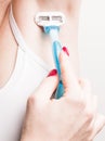 Close up of hand woman shaves armpit disposable razor. Armpits care concept Royalty Free Stock Photo