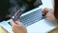 Close up hand of woman transaction credit card on laptop