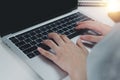 Close up hand woman typing keyboard computer laptop on desk.Business technology online and communication on desk Royalty Free Stock Photo