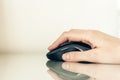 Close-up of hand woman using a computer mouse on glass table, business concept Royalty Free Stock Photo