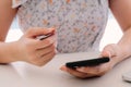 Close up hand of woman using smart phone and holding credit card for online shopping Royalty Free Stock Photo