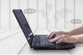 Close-up of hand woman working on laptop with talk icon and world map on wood. Royalty Free Stock Photo