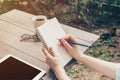 Close up hand woman writing notebook on wood table. Royalty Free Stock Photo