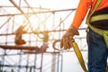 Close up hand of Worker in construction site Working at height equipment. Fall arrestor device for worker with hooks for safety Royalty Free Stock Photo