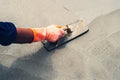 close up hand worker leveling concrete pavement for mix cement a Royalty Free Stock Photo