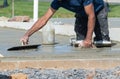 close up hand worker leveling concrete pavement for mix cement at construction site Royalty Free Stock Photo