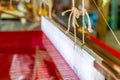 Close Up Hand Woven Cotton Weaver Machine Loom with Red Silk Thread for made Fabric