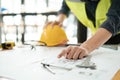 Close up of hand& x27;s architects working on blueprints in the office with drawing tools and a blueprint on his desk. Royalty Free Stock Photo