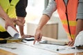 Close up of hand& x27;s architects working on blueprints in the office with drawing tools and a blueprint on his desk. Royalty Free Stock Photo