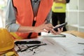 Close up of hand& x27;s architects working on blueprints in the office with drawing tools and a blueprint on his desk. Royalty Free Stock Photo