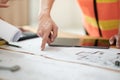 Close up of hand& x27;s architects working on blueprints in the office with drawing tools and a blueprint on his desk. Royalty Free Stock Photo