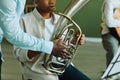 Close-up of hand of young African American music teacher helping schoolboy Royalty Free Stock Photo