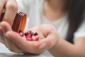 Close up hand of young asian woman taking medicine overdose trying to kill herself, Sick woman take a Royalty Free Stock Photo