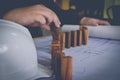 Close up hand of Young business man holding wooden model for working on his plane project at site construction work with morning Royalty Free Stock Photo