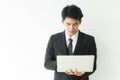Close up hand of young business man wearing black suit standing and using laptop computer Royalty Free Stock Photo