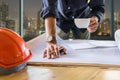 Close up hand of Young Engineer man holding cup of coffee and pe Royalty Free Stock Photo